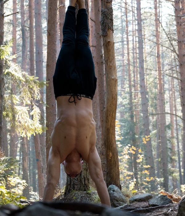 Man performing a controlled bodyweight exercise in a calm environment.